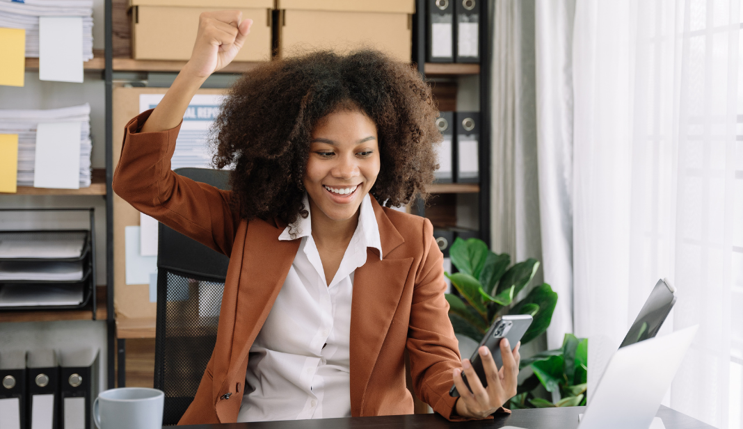 woman holding her phone and smiling