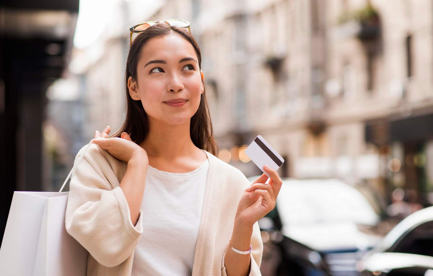 woman-outdoors-holding-credit-card-shopping-bag