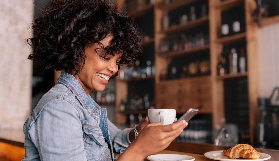 woman looking at her phone and smiling